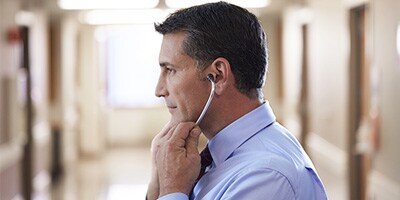 male clinician trying littmann stethoscope
